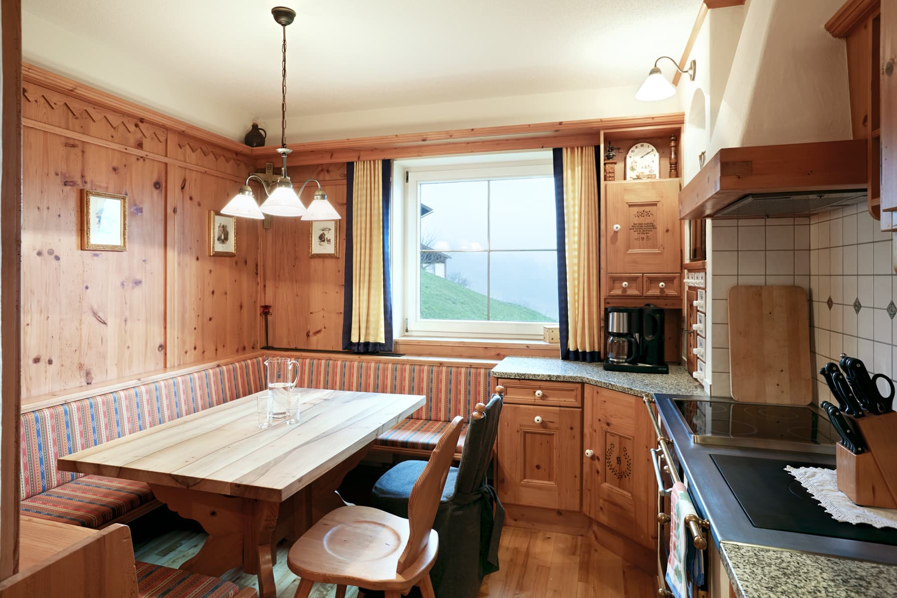 Kitchen-diner with corner bench and wood panelling