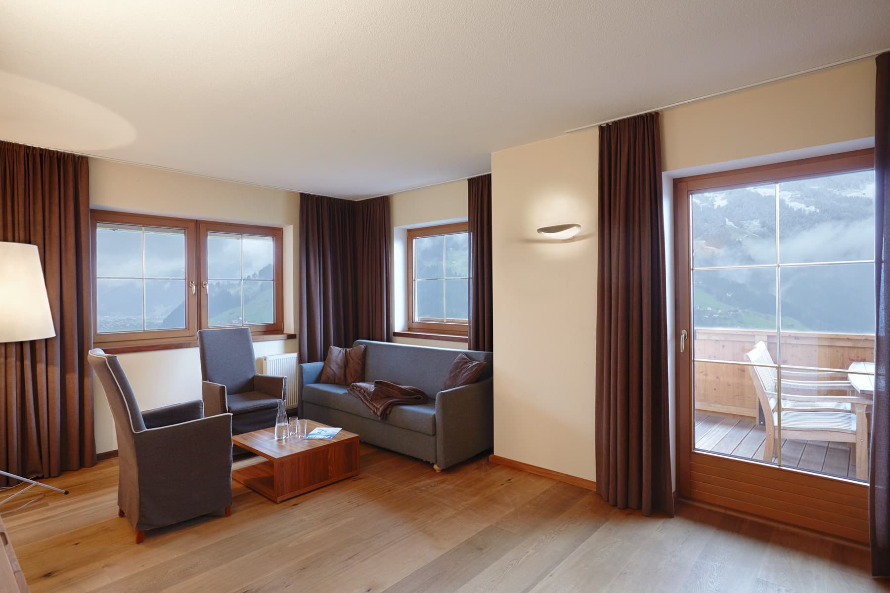 Living room with seating and door to the balcony